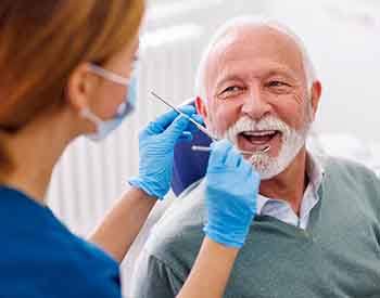 Man smiles at dentist