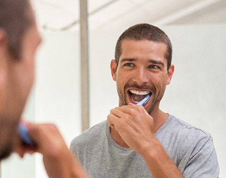 Fort Smith patient brushing to protect white teeth
